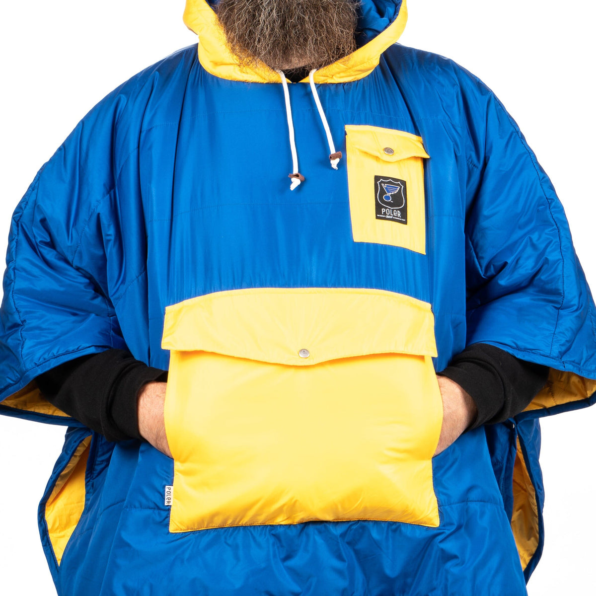 Hands in the kangaroo pocket of a St. Louis Blues hockey poncho