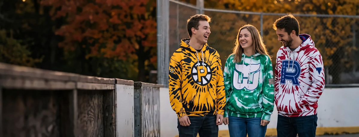 Friends at an outdoor hockey rink in Bench Clearers tie-dye hockey hoodies - Providence Bruins, Hartford Whalers and Laval Rocket