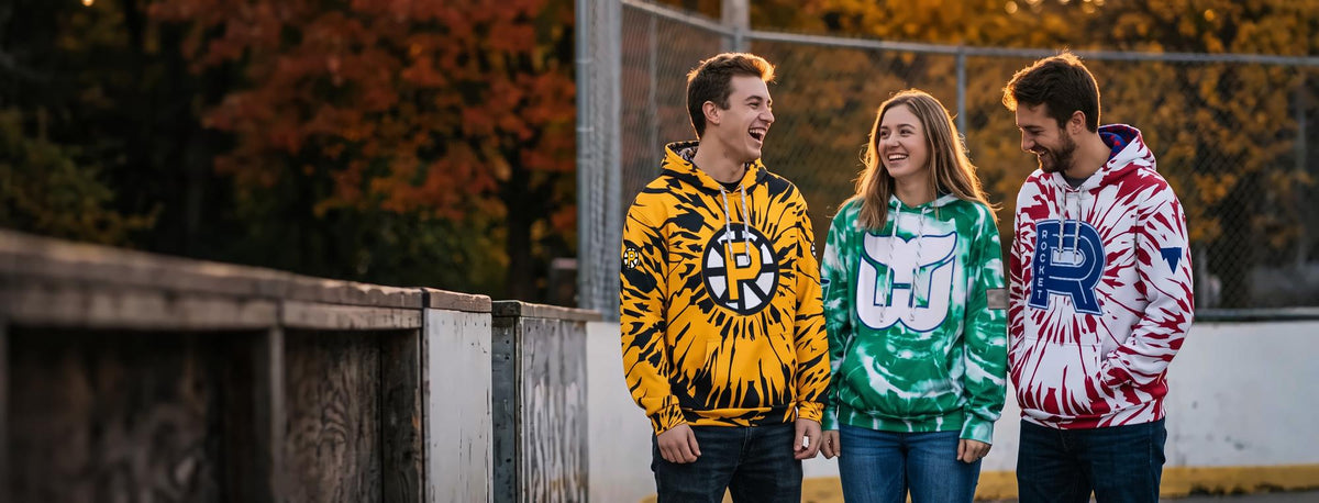 Friends at an outdoor hockey rink in Bench Clearers tie-dye hockey hoodies - Providence Bruins, Hartford Whalers and Laval Rocket