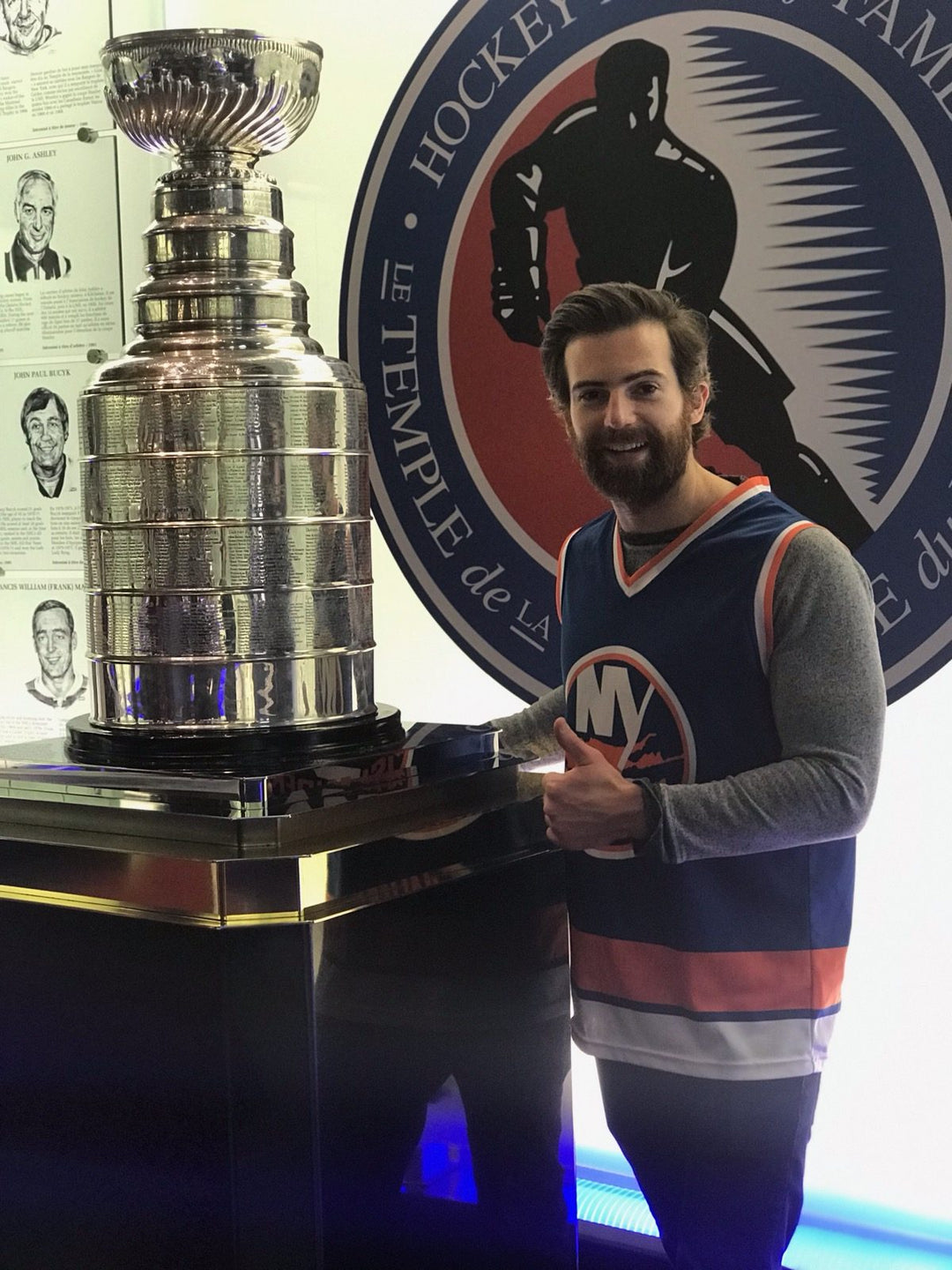 Wearing a Bench Clearers New York Islanders hockey tank next to the Stanley Cup at the Hockey Hall of Fame