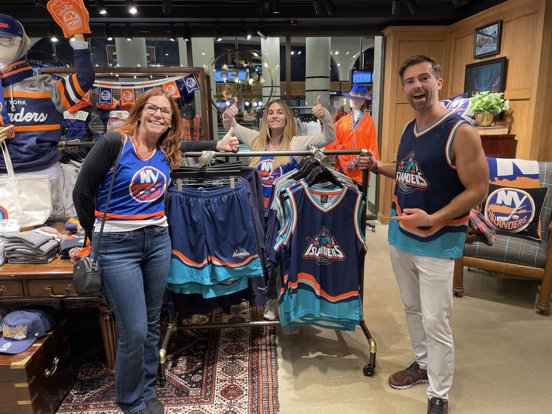 Bench Clearers New York Islanders Fisherman hockey tanks and shorts on the rack inside the Isles Lab team store at UBS Arena